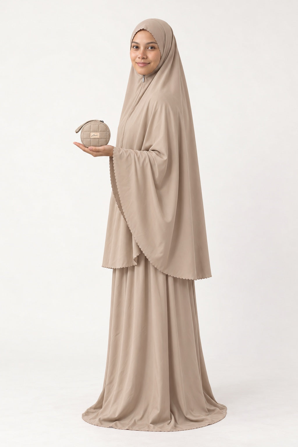 Pocket Mukena in Duha, beige, pouch resting on her palm