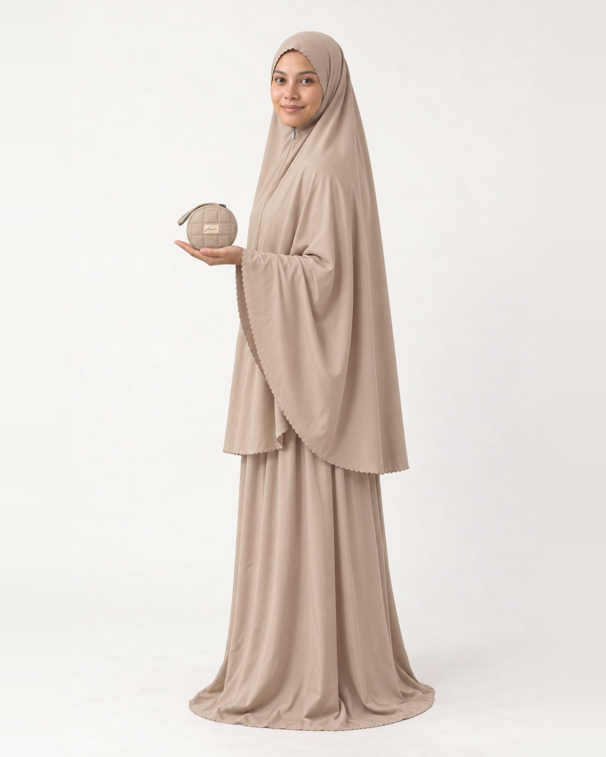 Pocket Prayer Outfit in Duha, beige, pouch resting on her palm