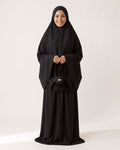 Pocket Prayer Outfit in Layl, black, holding the matching pouch