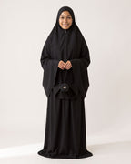 Pocket Prayer Outfit in Layl, black, holding the matching pouch
