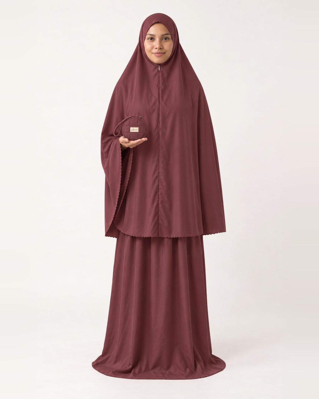 Pocket Prayer Outfit in Rumman, deep burgundy, pouch resting on her palm