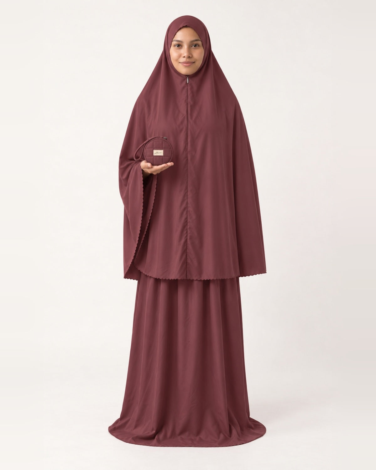 Pocket Prayer Outfit in Rumman, deep burgundy, pouch resting on her palm