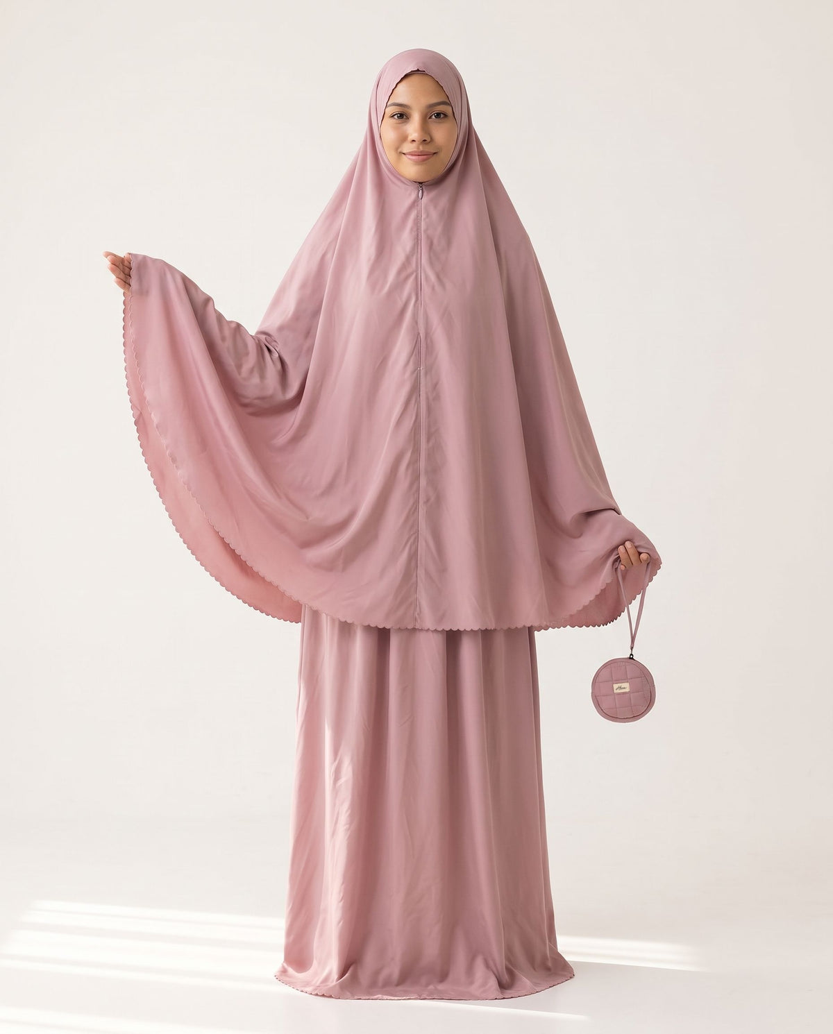 Pocket Mukena in Shafaq, arm raised to show the wide khimar