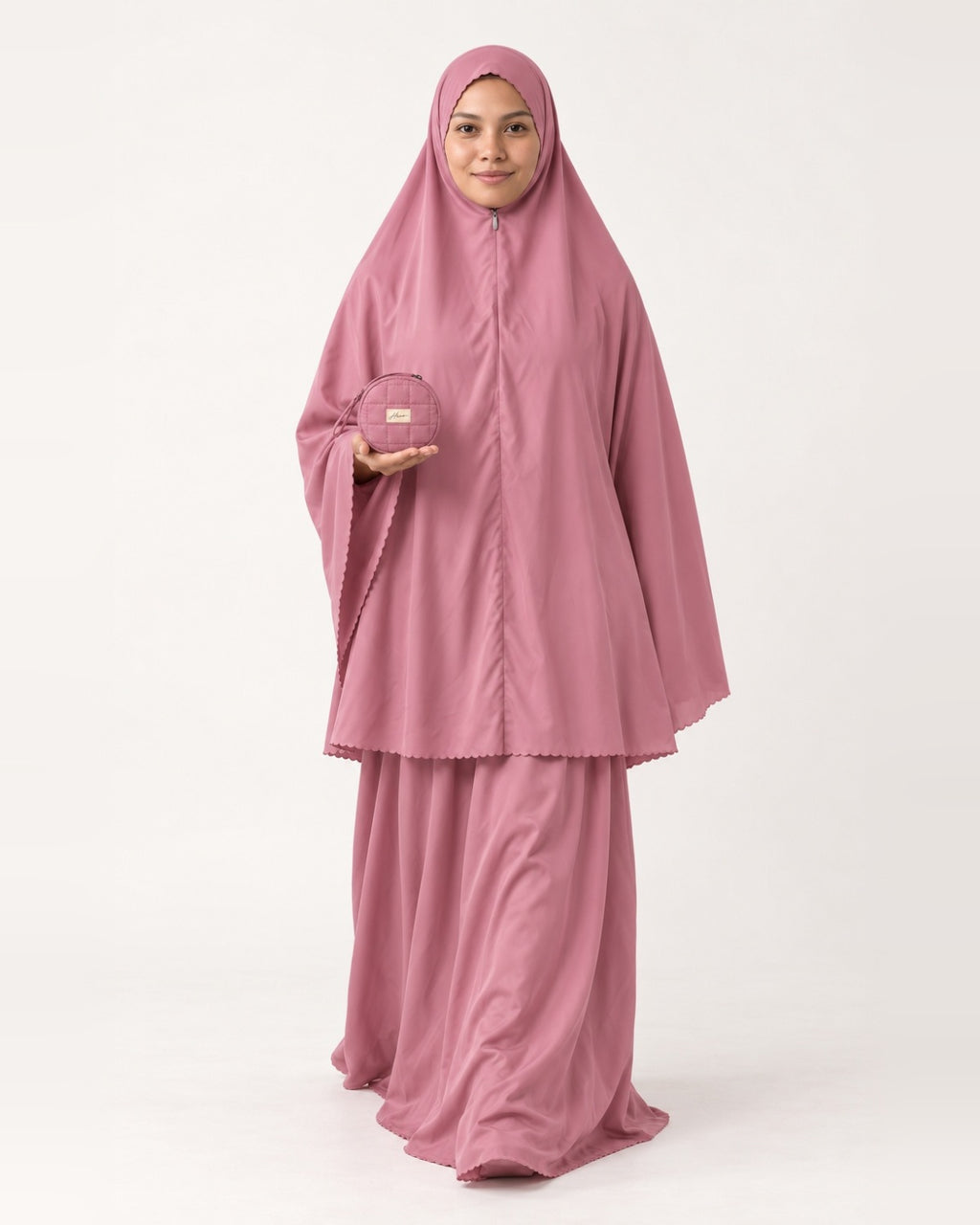 Pocket Prayer Outfit in Warda, rose pink, pouch resting on her palm