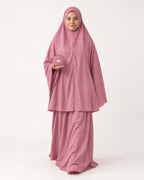 Pocket Prayer Outfit in Warda, rose pink, pouch resting on her palm