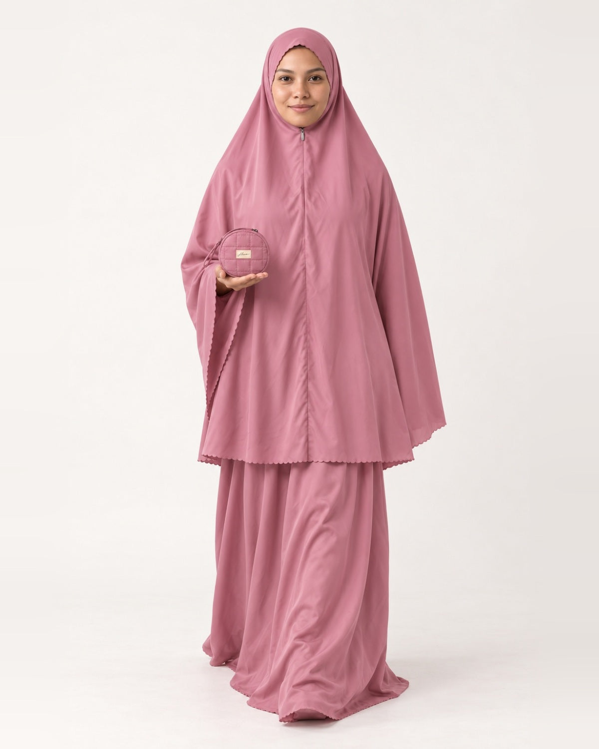 Pocket Prayer Outfit in Warda, rose pink, pouch resting on her palm